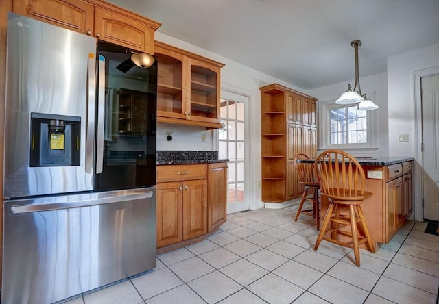 kitchen with light tile patterned floors, open shelves, and stainless steel fridge with ice dispenser