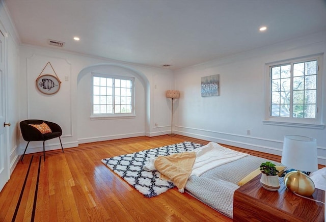 interior space featuring visible vents, baseboards, recessed lighting, wood finished floors, and arched walkways