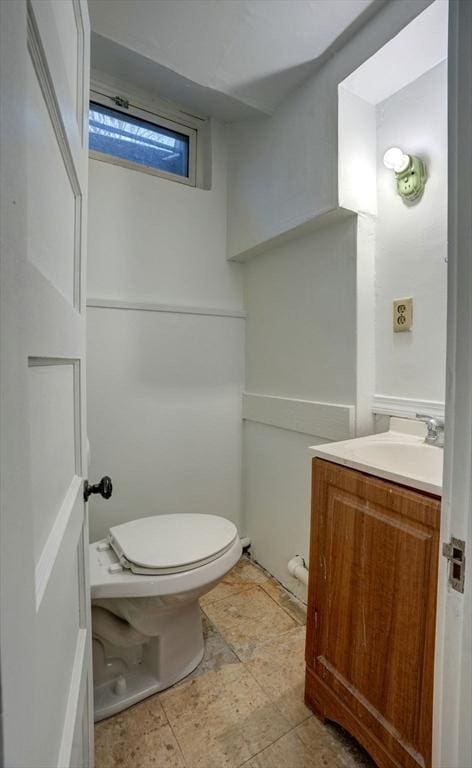 bathroom featuring toilet and vanity