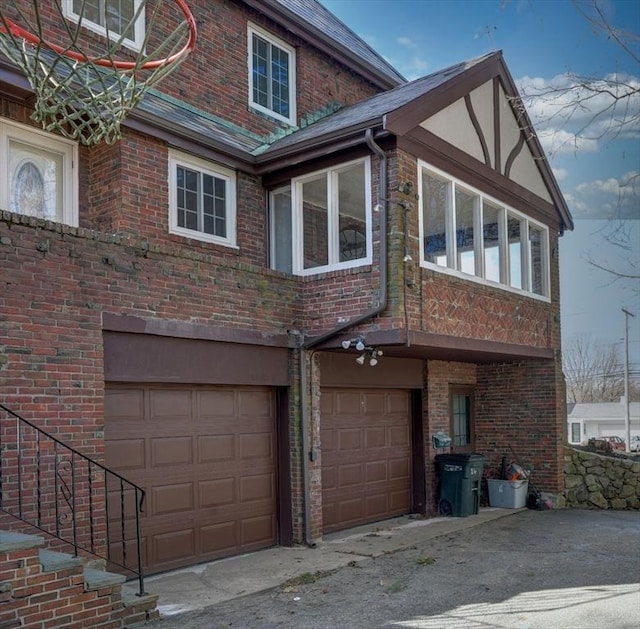 view of side of property with brick siding and a garage