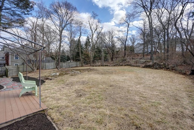 view of yard with a wooden deck and fence