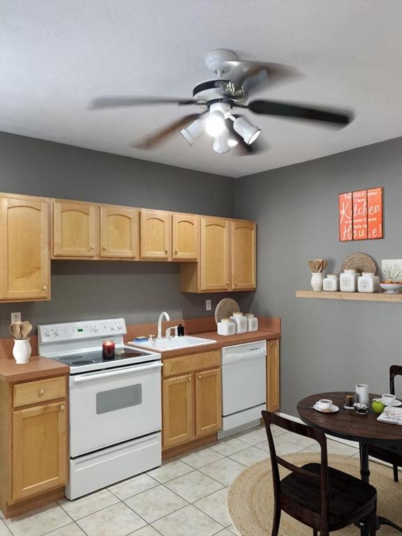 346 Lovell St, Worcester, MA 01602 - kitchen with white appliances, light brown cabinetry, a ceiling fan, and light tile patterned floors