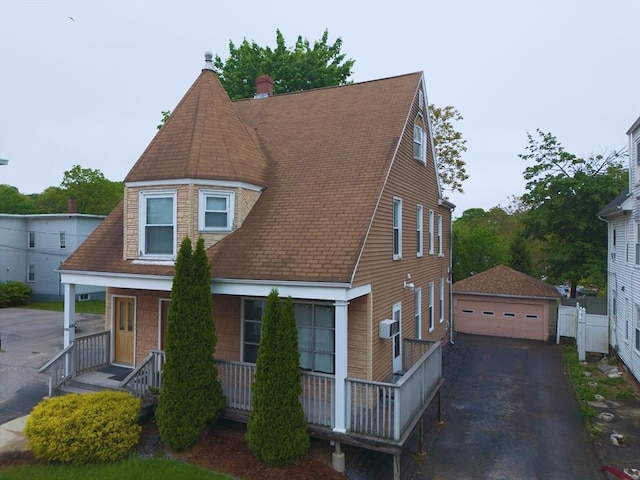 346 Lovell St, Worcester, MA 01602 - view of front of property with an outbuilding, a detached garage, a shingled roof, and covered porch