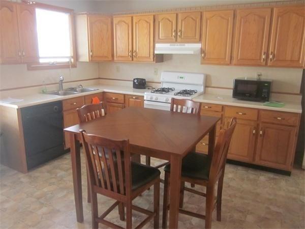 346 Lovell St, Worcester, MA 01602 - kitchen featuring black appliances, range hood, light countertops, and light flooring