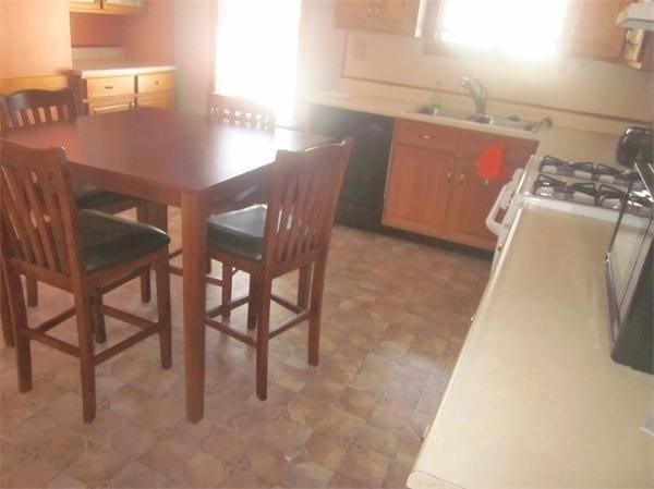 346 Lovell St, Worcester, MA 01602 - kitchen with extractor fan, light floors, light countertops, and white gas range