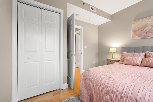 bedroom with a closet and light hardwood / wood-style floors