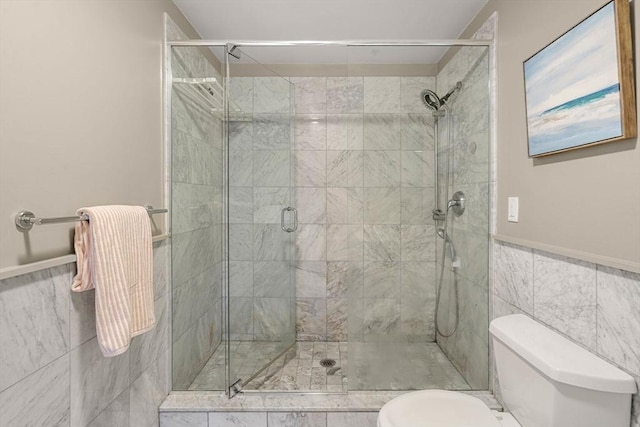 bathroom with toilet, tile walls, and walk in shower