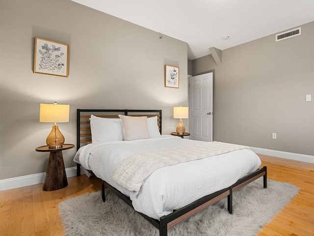 bedroom with wood-type flooring