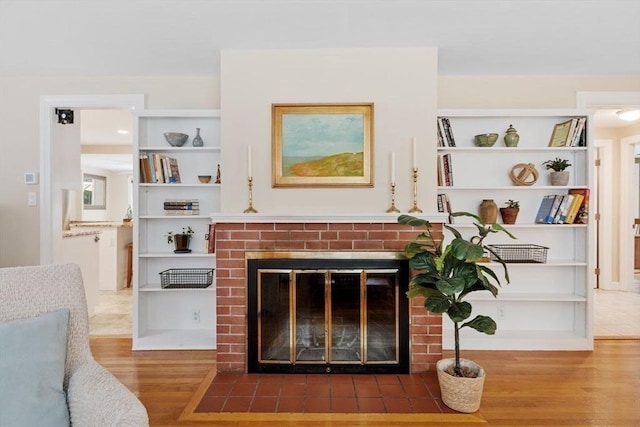 20 Chandler Rd, Andover, MA 01810 - living area with wood finished floors, a brick fireplace, and built in features