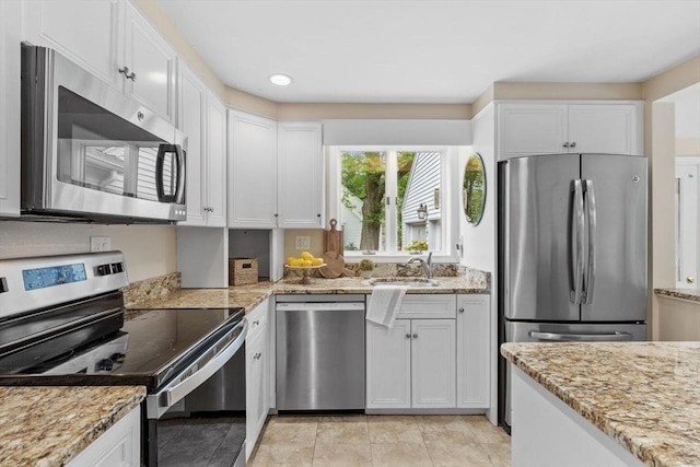 20 Chandler Rd, Andover, MA 01810 - kitchen with stainless steel appliances, white cabinets, light stone countertops, recessed lighting, and light tile patterned floors
