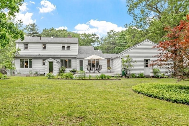 20 Chandler Rd, Andover, MA 01810 - back of property featuring a yard, a chimney, and roof with shingles