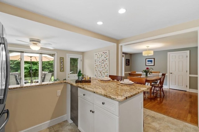 20 Chandler Rd, Andover, MA 01810 - kitchen with light stone countertops, white cabinets, freestanding refrigerator, ceiling fan, and recessed lighting