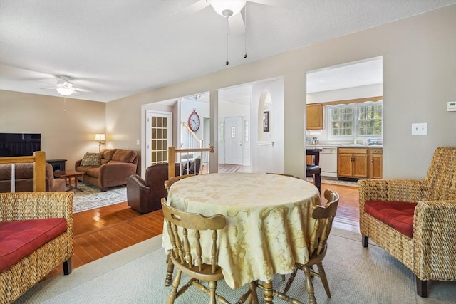 dining space featuring ceiling fan and light wood finished floors