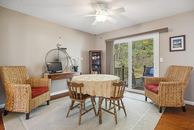 dining area with baseboards, a ceiling fan, and light wood-style flooring