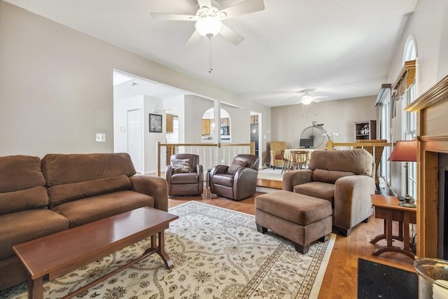 living area featuring a ceiling fan and light wood-style flooring