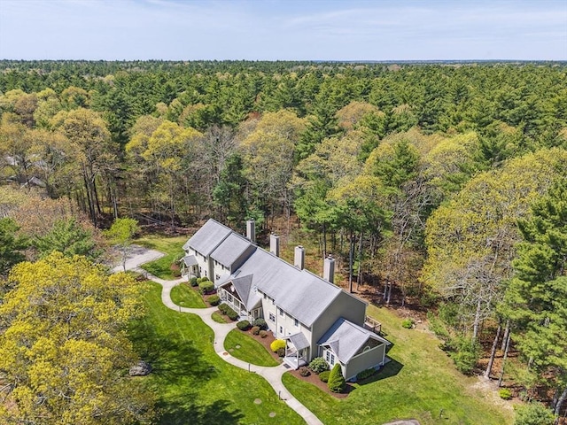 drone / aerial view featuring a wooded view