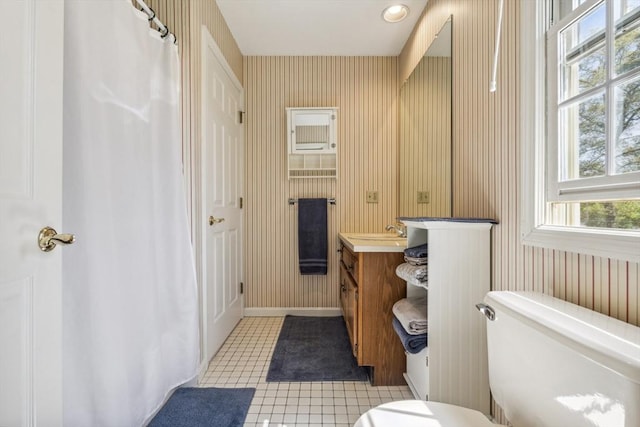full bath with vanity, toilet, baseboards, wallpapered walls, and tile patterned floors