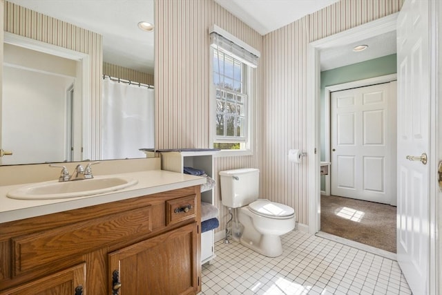 full bathroom featuring vanity, tile patterned flooring, toilet, baseboards, and wallpapered walls