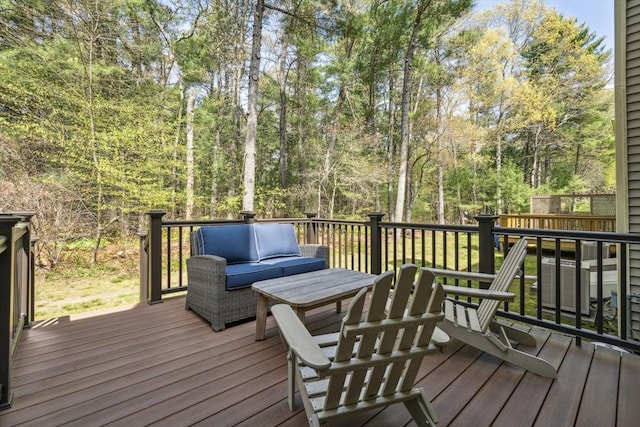 wooden terrace with outdoor lounge area and cooling unit
