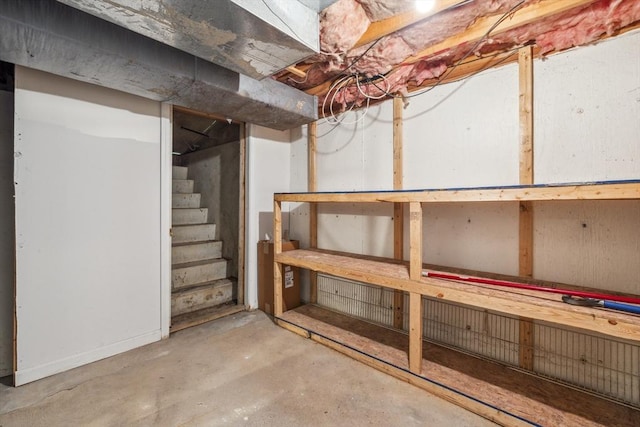 unfinished basement featuring stairs