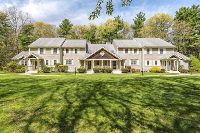 view of front of home with a porch and a front yard