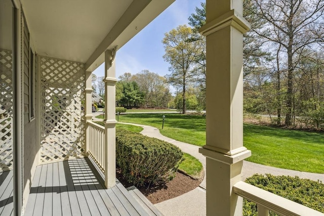 exterior space with covered porch and a yard