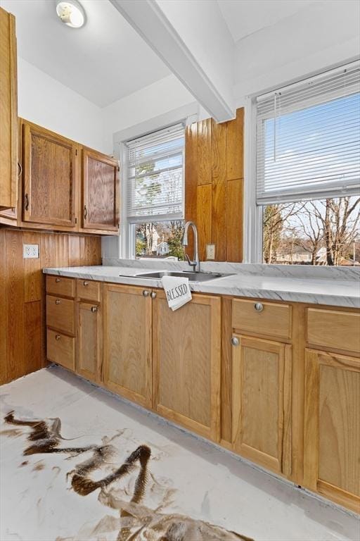 kitchen with beam ceiling and sink