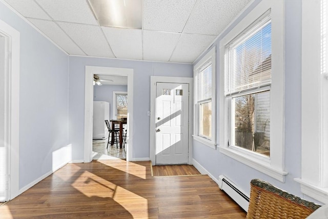 entryway featuring a paneled ceiling, ceiling fan, plenty of natural light, and a baseboard radiator