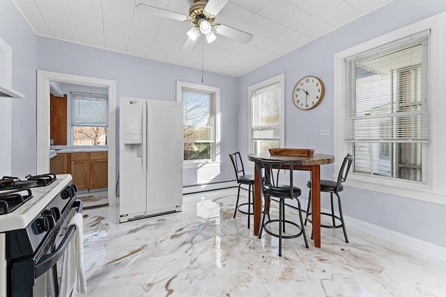 dining area featuring ceiling fan and baseboard heating