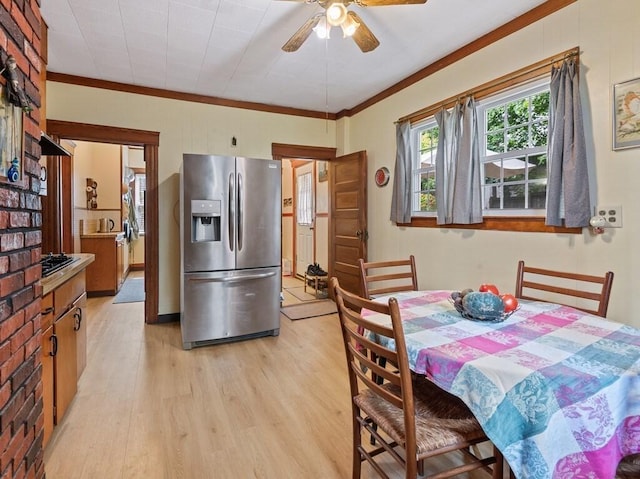 dining room with ceiling fan, light wood-type flooring, and ornamental molding