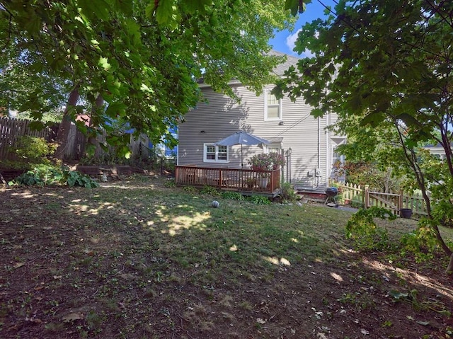 view of yard with a wooden deck and fence