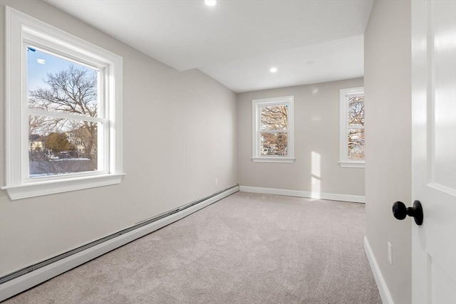 carpeted empty room with a baseboard radiator