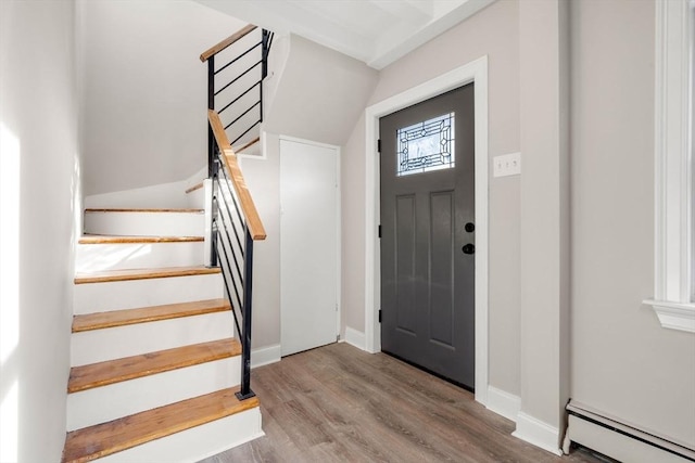 foyer with a baseboard radiator and light hardwood / wood-style flooring