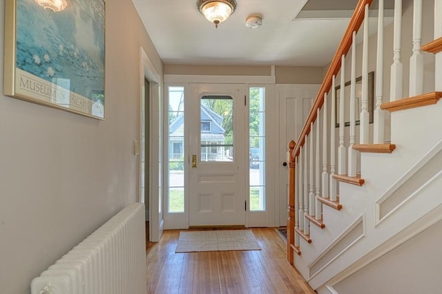 21 Mechanic St, Holliston, MA 01746 - foyer entrance with radiator, hardwood / wood-style floors, and stairs