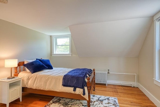 21 Mechanic St, Holliston, MA 01746 - bedroom with radiator, wood finished floors, lofted ceiling, and baseboards