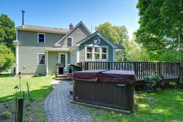 21 Mechanic St, Holliston, MA 01746 - rear view of house with a hot tub, a deck, a lawn, and a chimney
