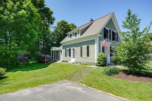 21 Mechanic St, Holliston, MA 01746 - view of front of property featuring a chimney, a front yard, a deck, and a shingled roof