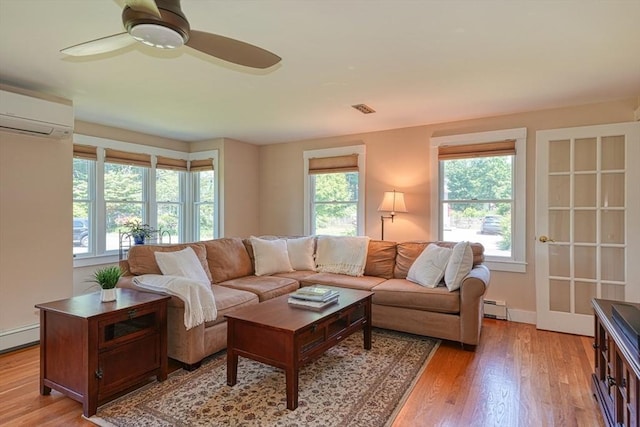 21 Mechanic St, Holliston, MA 01746 - living area featuring a wall mounted air conditioner, baseboard heating, light wood-style flooring, and a ceiling fan
