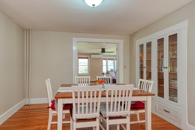21 Mechanic St, Holliston, MA 01746 - dining room featuring a wall mounted air conditioner, light wood-style flooring, french doors, baseboards, and a ceiling fan