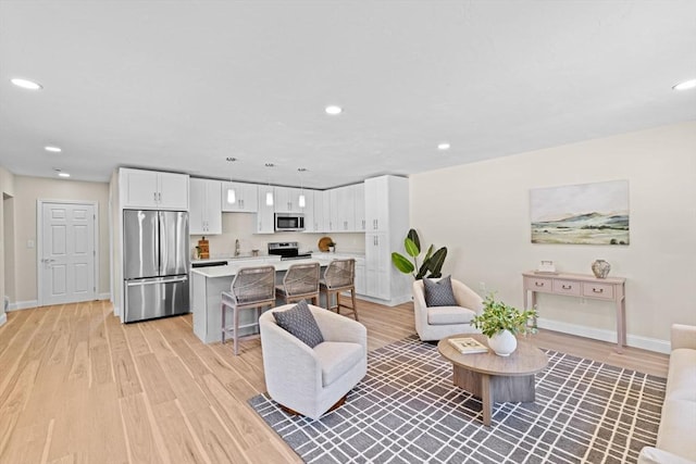 69 Wood St, Hanson, MA 02341 - living area featuring light wood-type flooring and recessed lighting