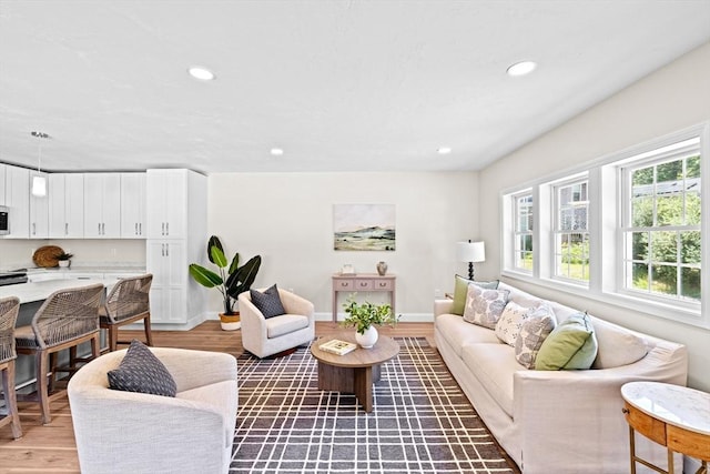 69 Wood St, Hanson, MA 02341 - living area with light wood-style flooring and recessed lighting