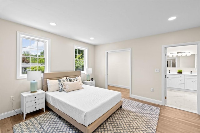 69 Wood St, Hanson, MA 02341 - bedroom featuring light wood-style flooring, connected bathroom, and recessed lighting