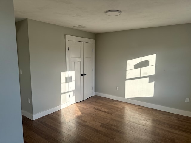 spare room with dark hardwood / wood-style floors