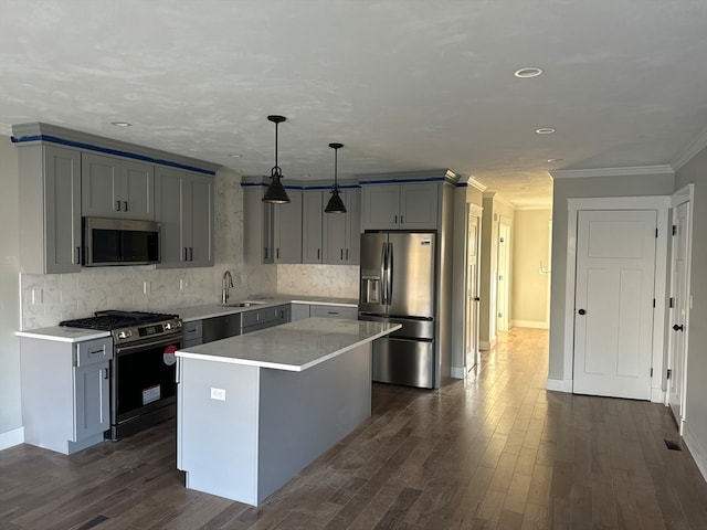 kitchen with dark hardwood / wood-style floors, stainless steel appliances, a kitchen island, and hanging light fixtures