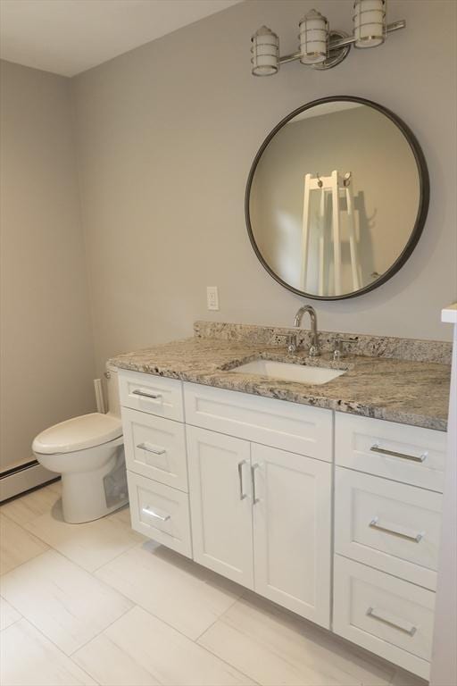 12 Hampton Ct, Walpole, MA 02032 - bathroom with vanity, baseboard heating, toilet, and tile patterned floors