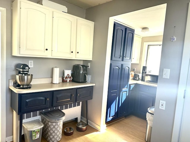 interior space with baseboards and light wood finished floors