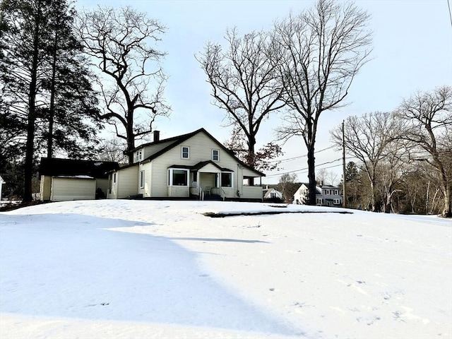 bungalow-style home with a garage and a chimney