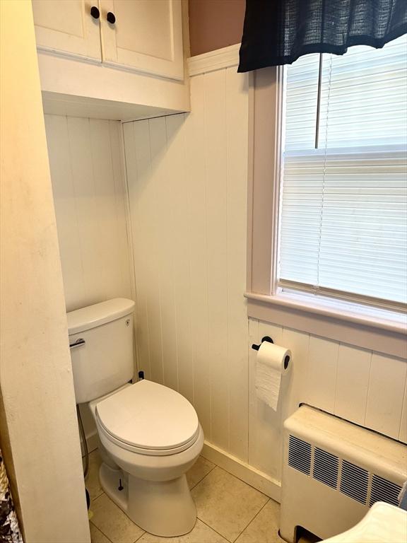 bathroom featuring radiator heating unit, toilet, and tile patterned floors