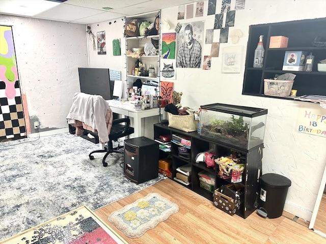 office area with a drop ceiling and wood finished floors