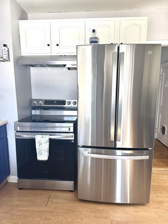 kitchen with white cabinets, light wood-style floors, appliances with stainless steel finishes, light countertops, and under cabinet range hood